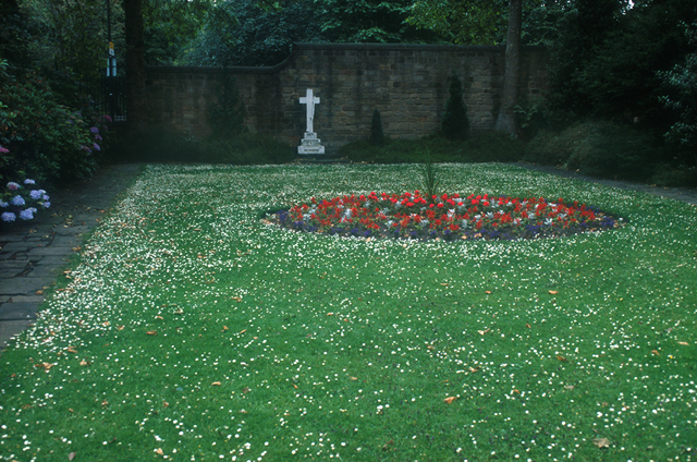In front of the wall between the Cooper Memorial Garden, next to St Mary's Church, and St Mary's Place. (SE434407)